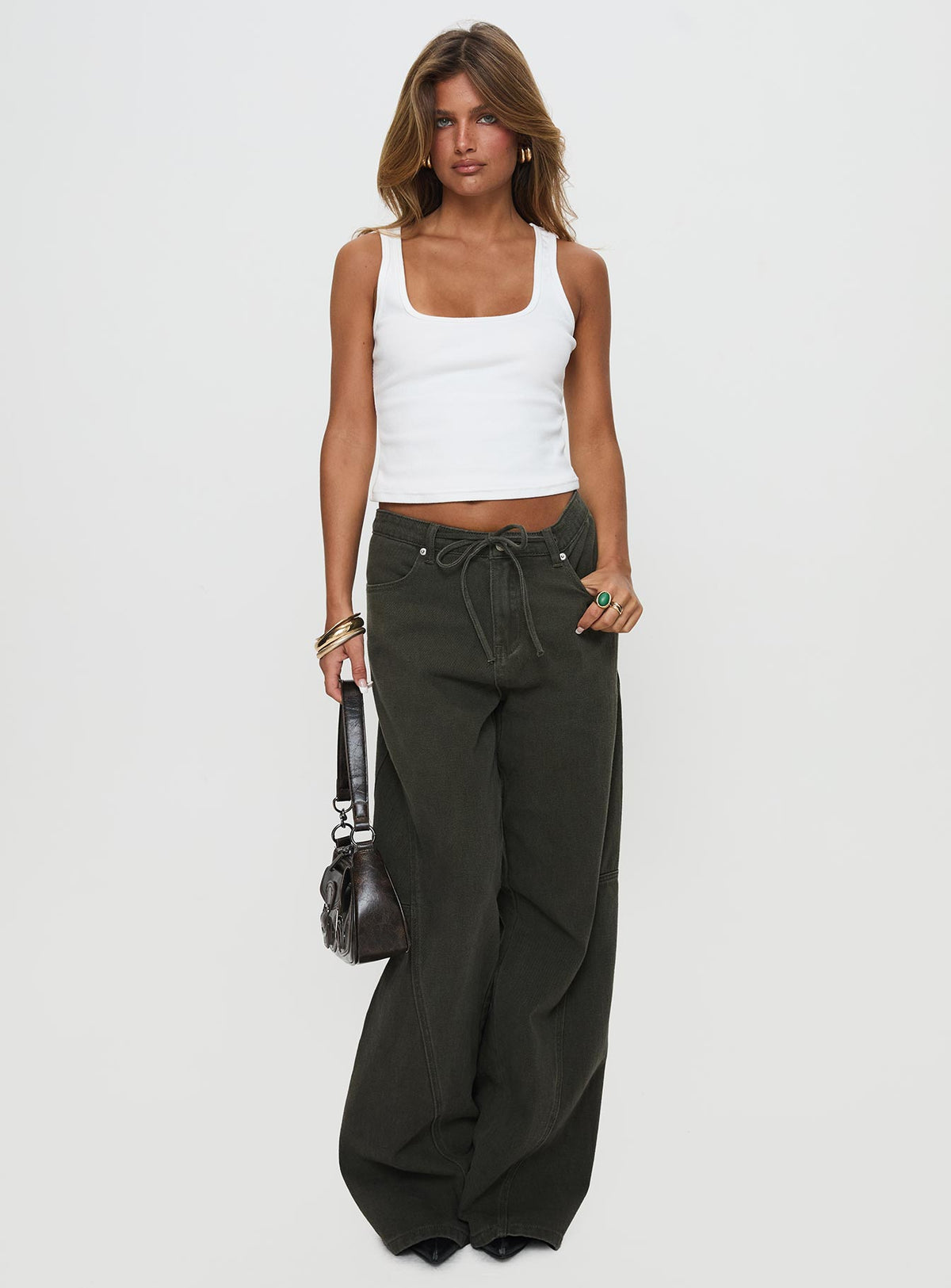 front view of model wearing Princess Polly Bruiser Tie Waist Mid Rise Wide Leg Jeans Green Petite High Rise Jeans 