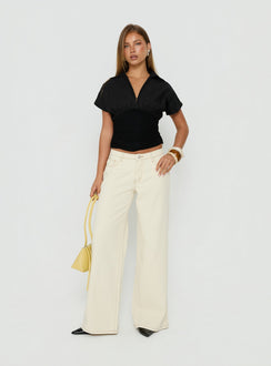 Showcasing the Ramos Low Rise Wide Leg Jeans Cream in womens jeans with low-rise waist front view of model wearing Princess Polly