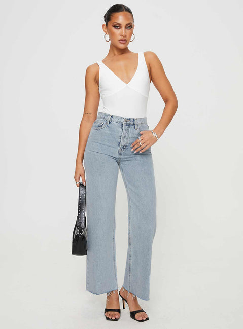 front view of model wearing Princess Polly Fawcett Jeans Light Wash Denim Petite High Waisted 
