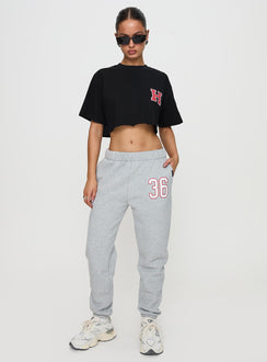 front view of model wearing Princess Polly Harvard Graphic Track Top Black Short Sleeves Crew Neck 