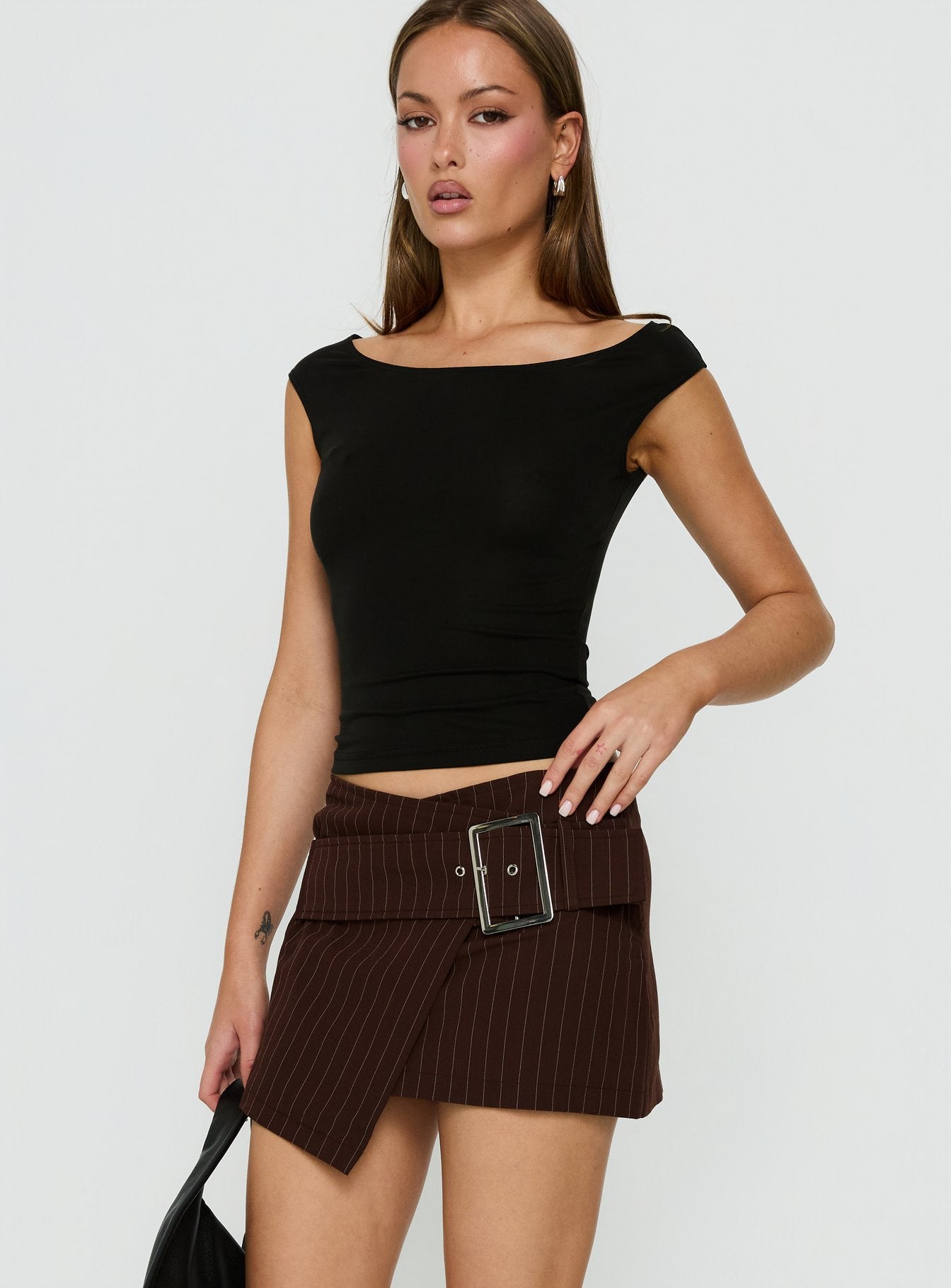 Crafted with the Myrienne Belted Mini Skirt Brown Pinstripe womens skirts in dark wash side view of model wearing Princess Polly
