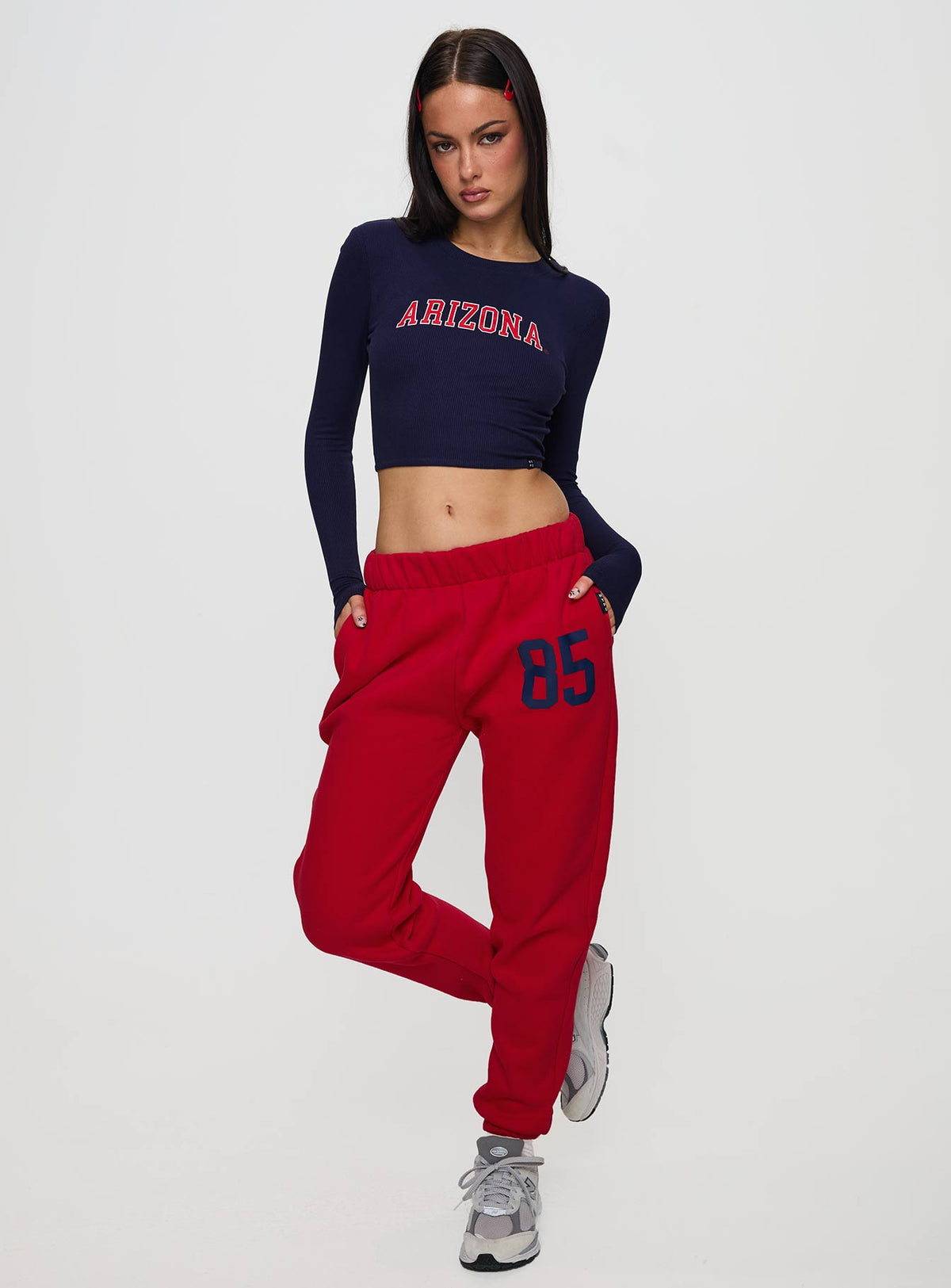 front view of model wearing Princess Polly U of A Bring It Back Long Sleeve Top Navy Full Sleeves Crew Neck 