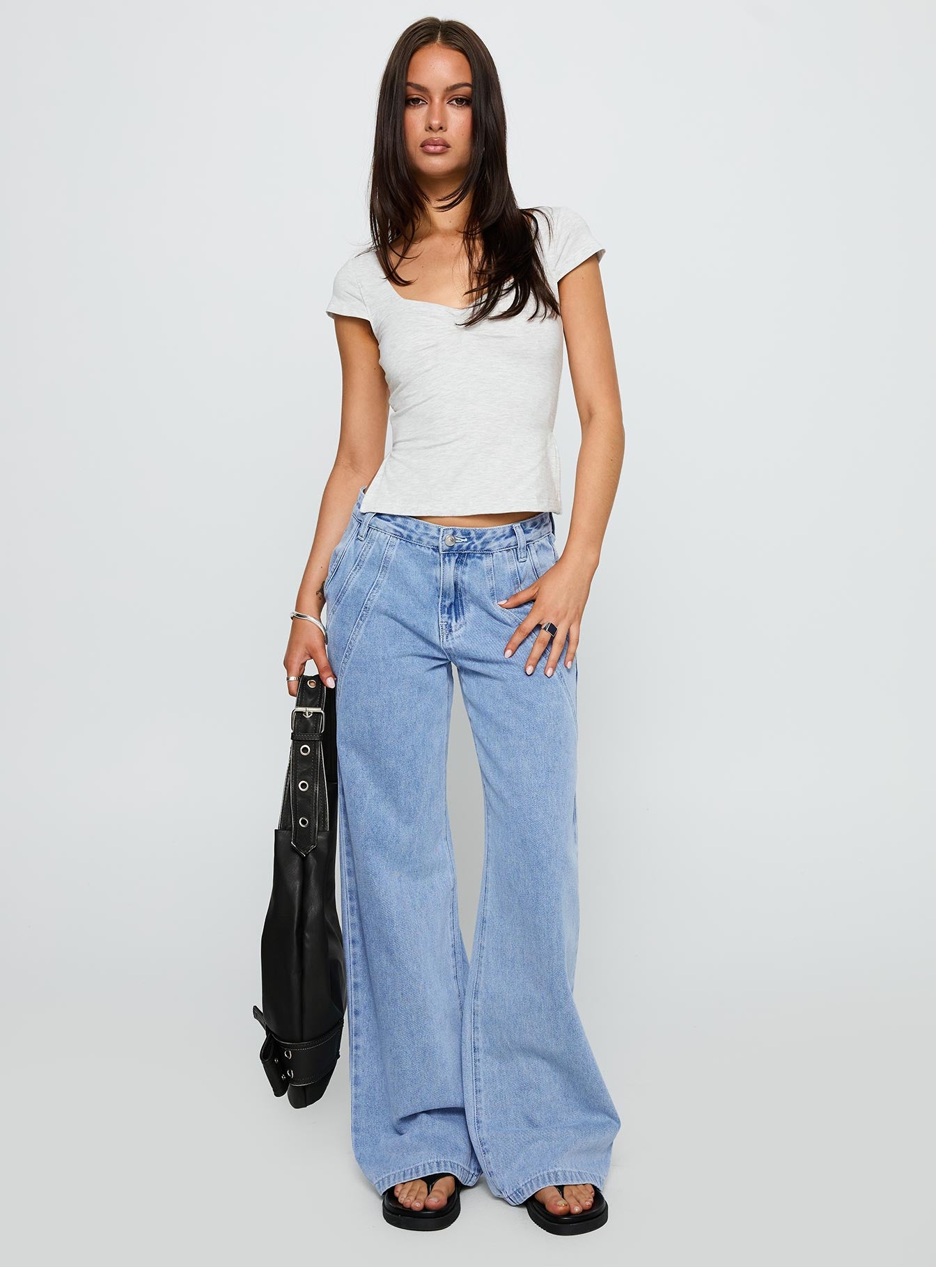 front view of model wearing Princess Polly Reaper Baggy Denim Jeans Light Blue Wash Mid Rise 