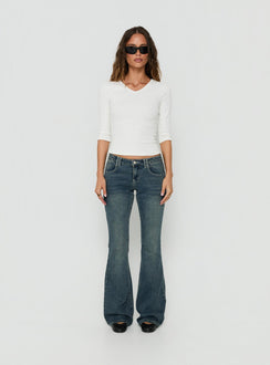 Showcasing the Clynee Ultra Low Rise Bootleg Jeans Dirty Blue in womens-jeans with low-rise waist front view of model wearing Princess Polly