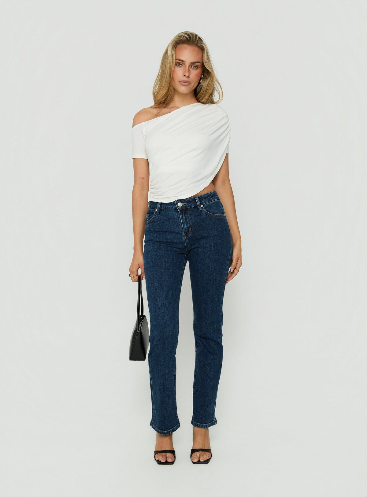 Model wearing Harpor Mid Rise Slim Skinny Jean Mid Blue Wash womens-jeans with belt detail view of model wearing Princess Polly