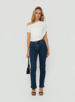 Model wearing Harpor Mid Rise Slim Skinny Jean Mid Blue Wash womens-jeans with belt detail view of model wearing Princess Polly