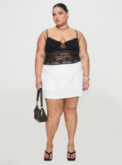 front view of model wearing Princess Polly Gigi Skort White Curve High Waisted Shorts 