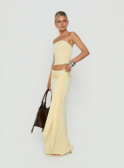 Presenting the Aymee Tie Detail Maxi Skirt in Yellow, a women's skirt with relaxed fit, lace hem, solid print, aline shape, and wrap details side view of model wearing Princess Polly