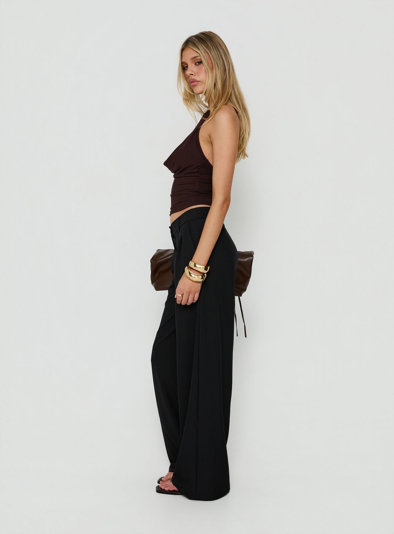 Explore the Archer Mid Rise Baggy Pants Black in womens-regular-pants side view of model wearing Princess Polly