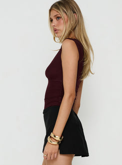 Featuring the Samaria Plunge Neck Bodysuit Burgundy in womens-bodysuit with sleeveless and ruched styling side view of model wearing