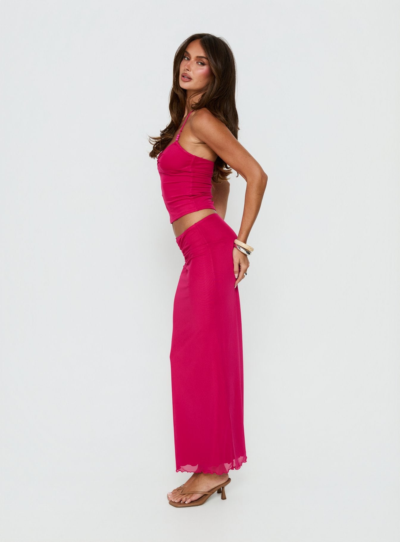   side view of model wearing Princess Polly Jailon Ruched Maxi Skirt Guava Maxi Skirts Skirts 