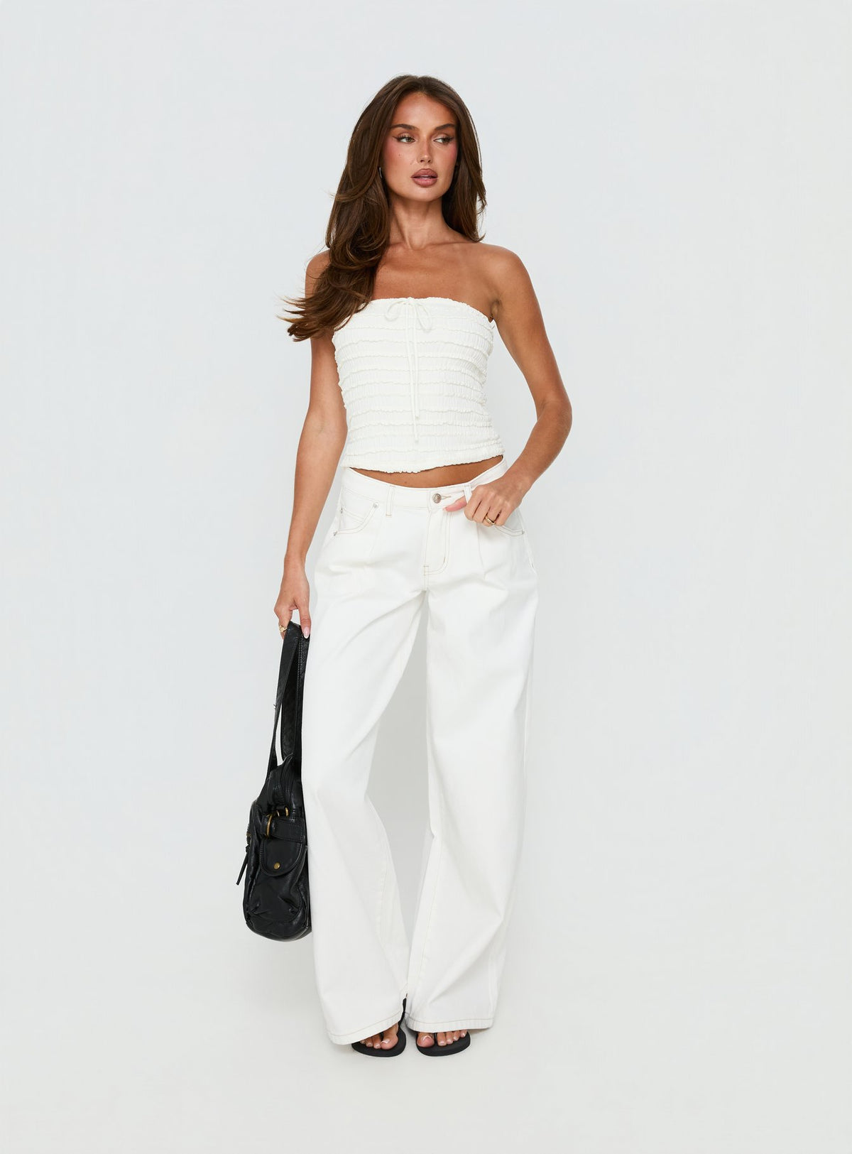 side view of model wearing Princess Polly Supercut Low Rise Baggy Pleat Jeans Cream Mid Rise Jeans Jeans 