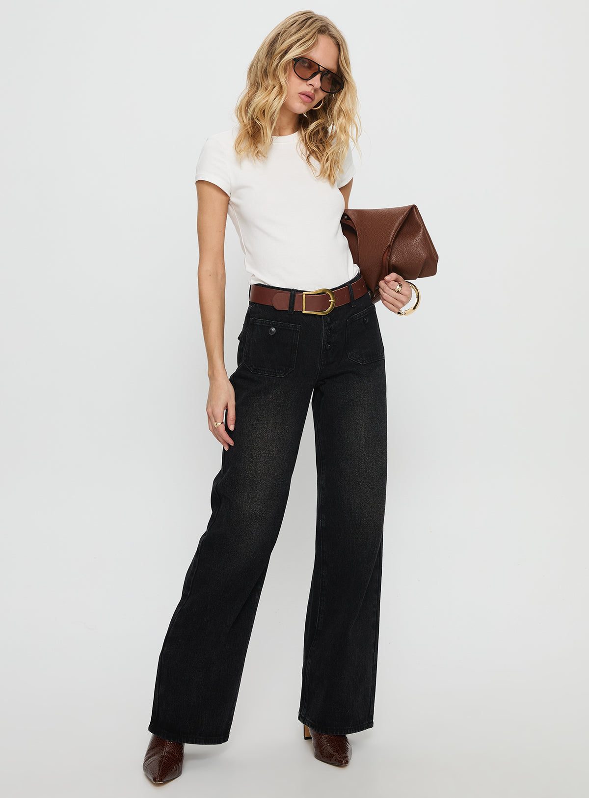 side view of model wearing Princess Polly Carianne Low Rise Wide Leg Jeans Washed Black Mid Rise Jeans 