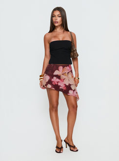   side view of model wearing Princess Polly Allissa Chiffon Asymmetrical Mini Skirt Burgundy Floral 