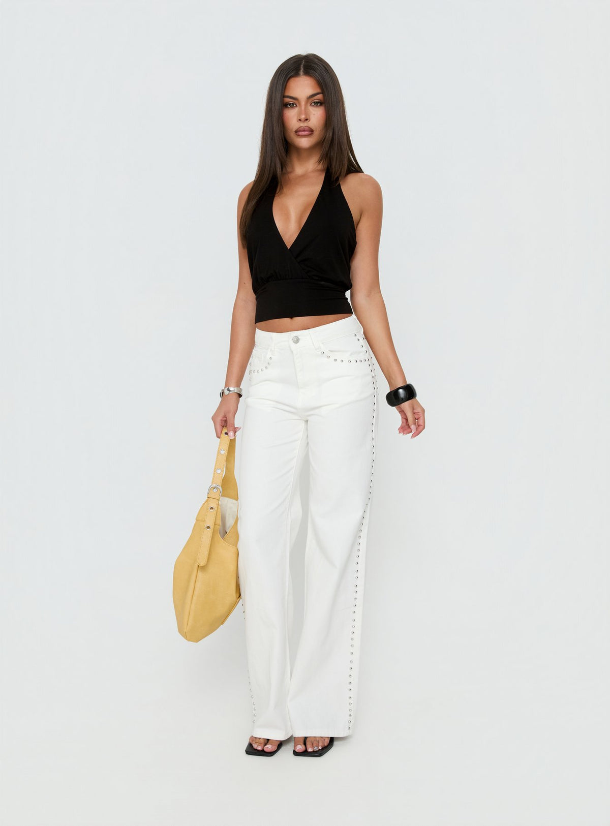 Featuring the Saving Up Mid Rise Straight Leg Studded Jeans White in womens-jeans with silver studded details front view of model wearing Princess Polly