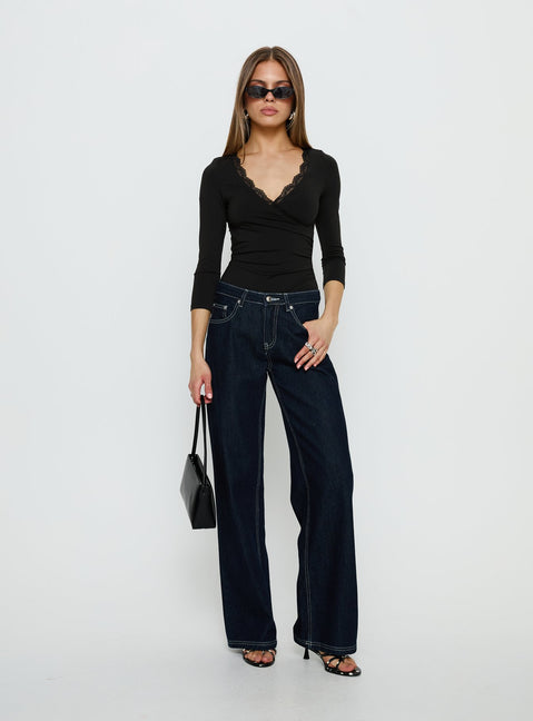 side view of model wearing Princess Polly Lyselle Wrap Detail 3/4 Sleeve Bodysuit Black Quarter Sleeve 