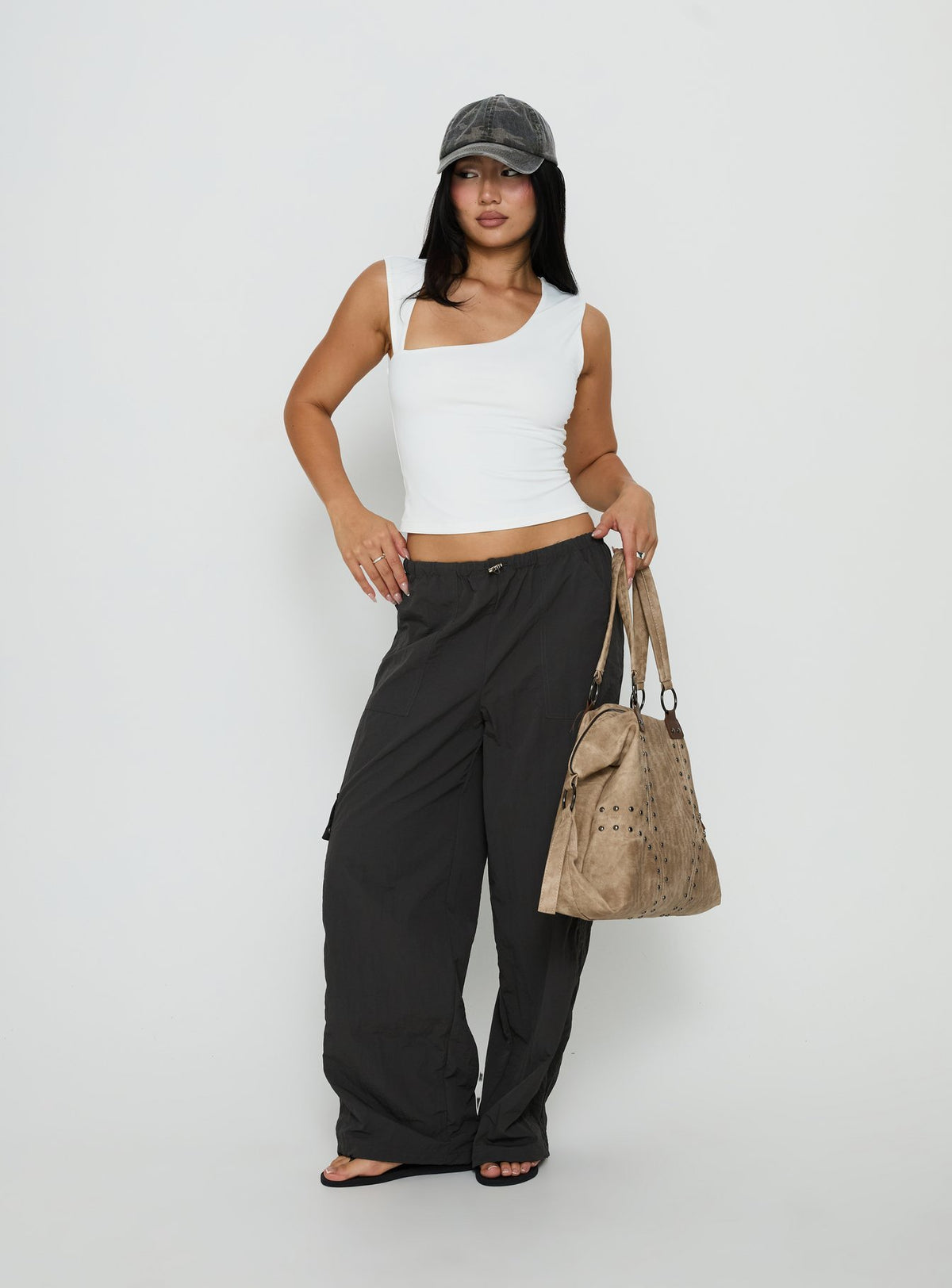 Showcasing the Lost On You Parachute Cargo Pants Charcoal in mid-rise womens-regular-pants front view of model wearing