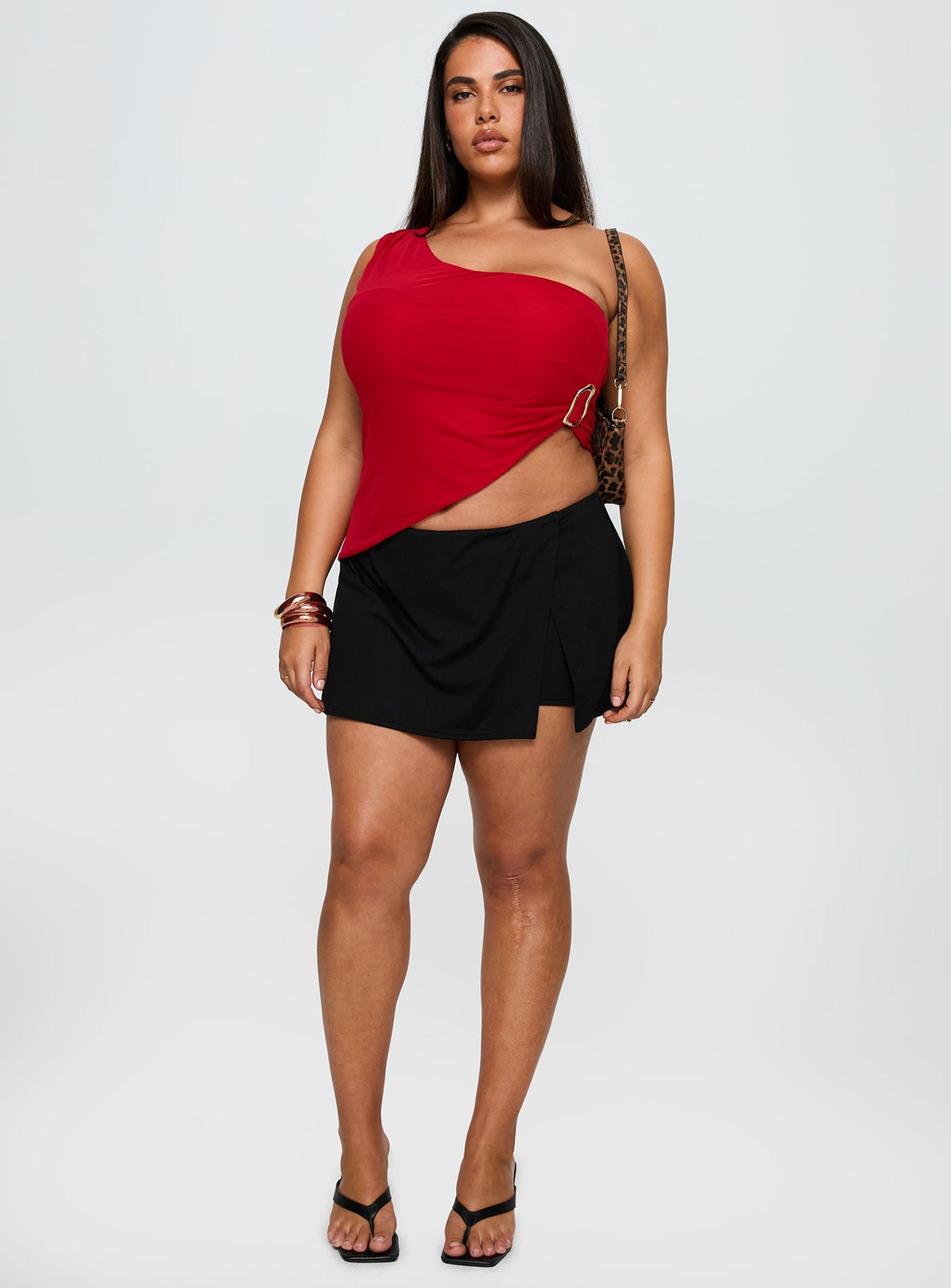 side view of model wearing Princess Polly Machiatto One Shoulder Top Red Curve Sleeveless Asymmetric Neckline 