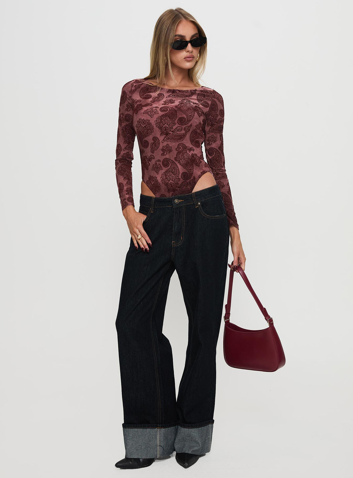 side view of model wearing Princess Polly Spruce Bodysuit Red Paisley Long Sleeve Tops 