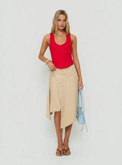 Discover the Ellainah Asymmetrical Wrap Midi Skirt Concrete in tan front view of model wearing Princess Polly