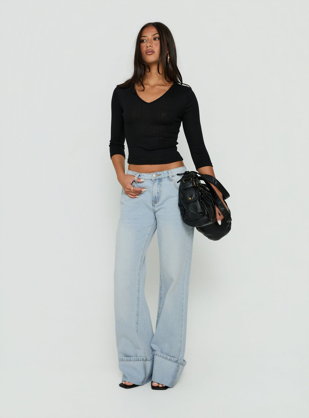 Showcasing Ezia Wide Cuff Baggy Jeans Light Blue Wash in womens-jeans with high-rise front view of model wearing Princess Polly