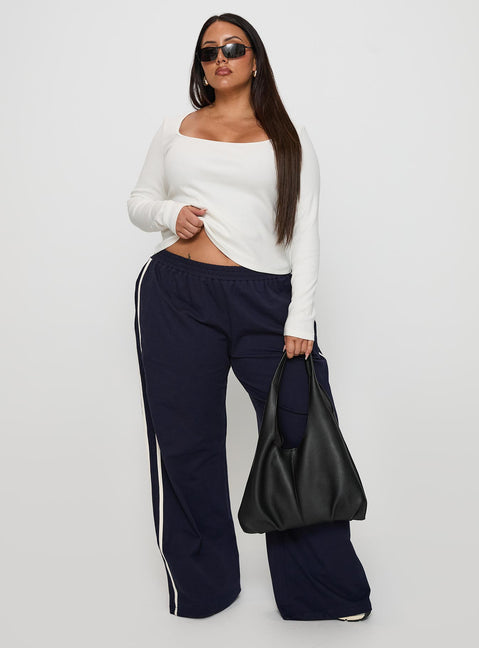 front view of model wearing Princess Polly Circuit Track Pants Navy Curve Pants 