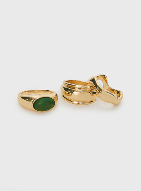 Three rings included, gold-toned, gem detail