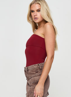 side view of model wearing Princess Polly Niner Strapless Bodysuit Burgundy Petite Sleeveless Bodysuit 