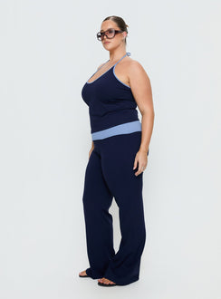 side view of model wearing Princess Polly Kobee Jersey Flare Pants Navy / Light Blue Curve High Rise Pants 