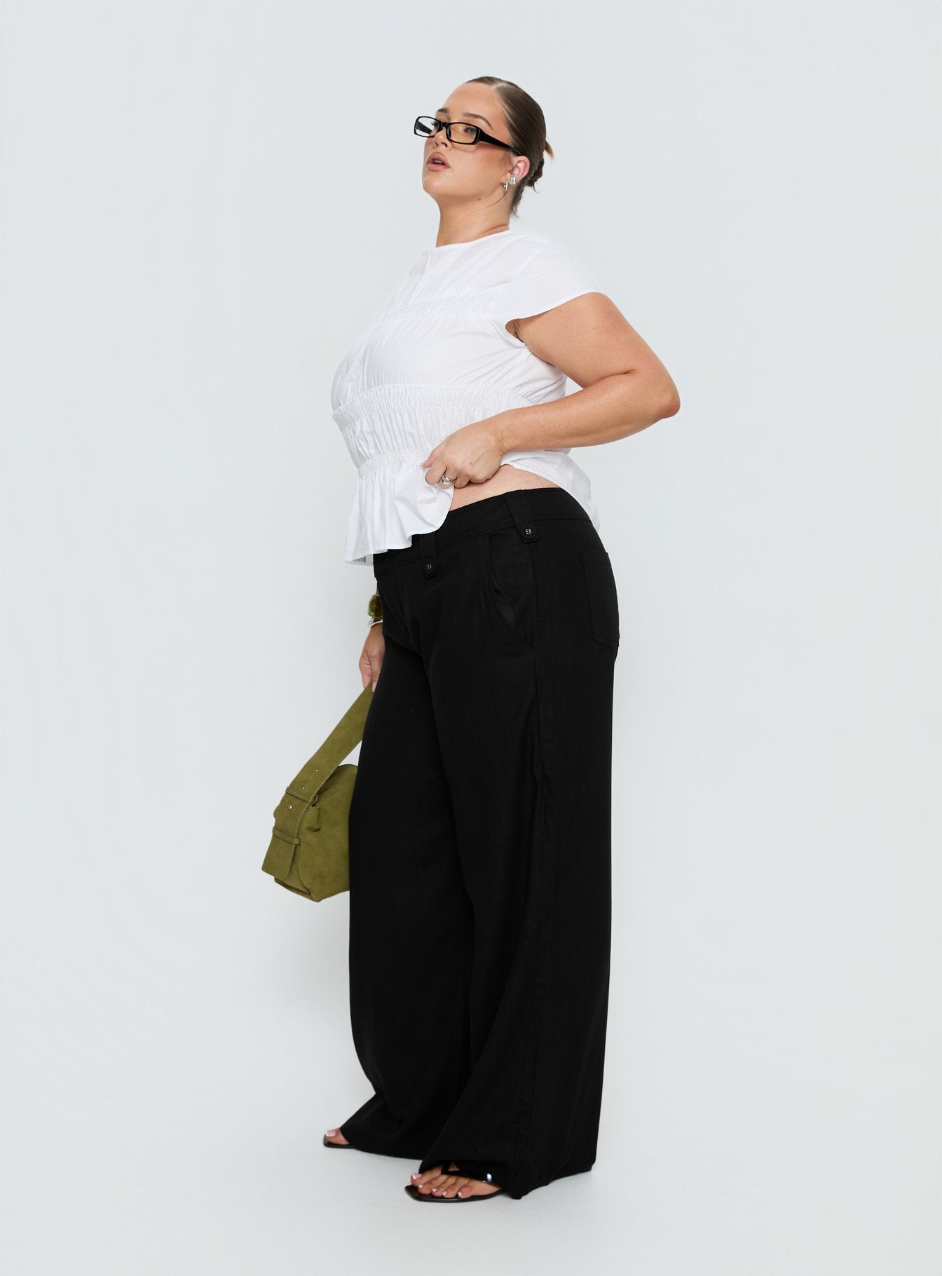 side view of model wearing Princess Polly Pedra Wide Leg Pant Black Curve Mid Rise Pants 