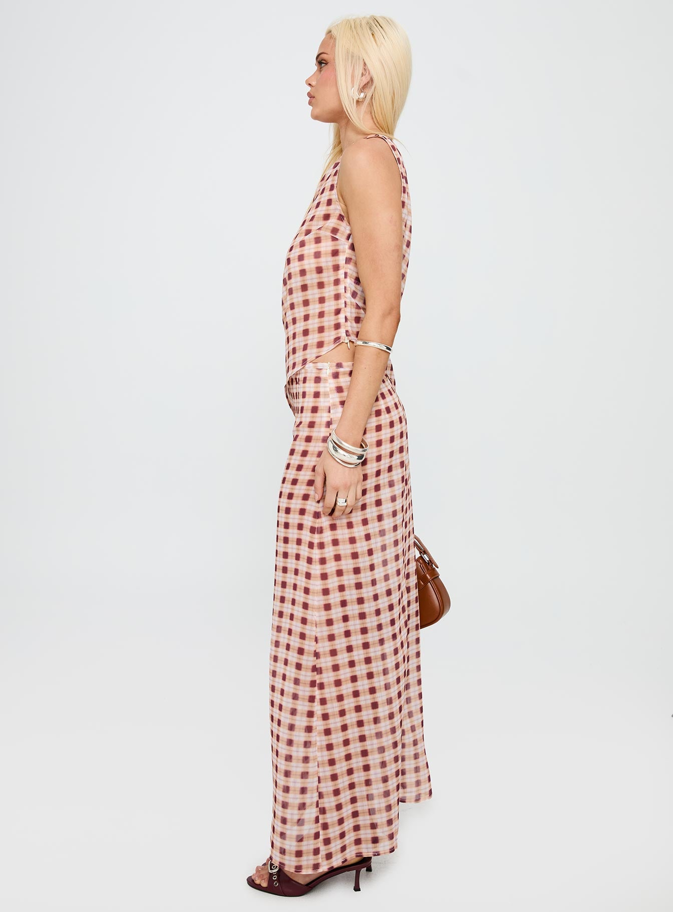   side view of model wearing Princess Polly Surina Skirt Peach Check Maxi 