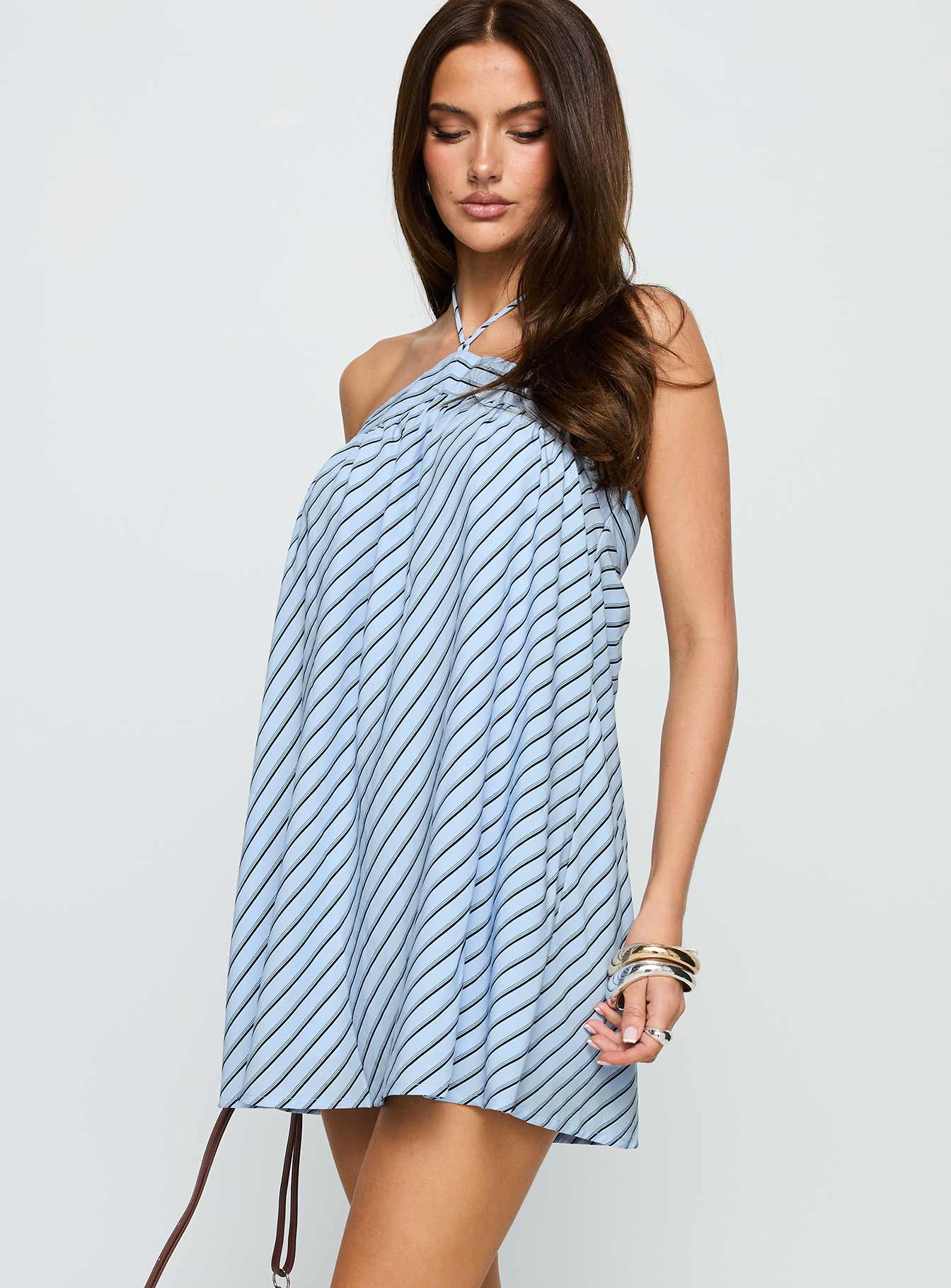 side view of model wearing Princess Polly Moonlit Mini Dress Blue Stripe Asymmetric Neckline 