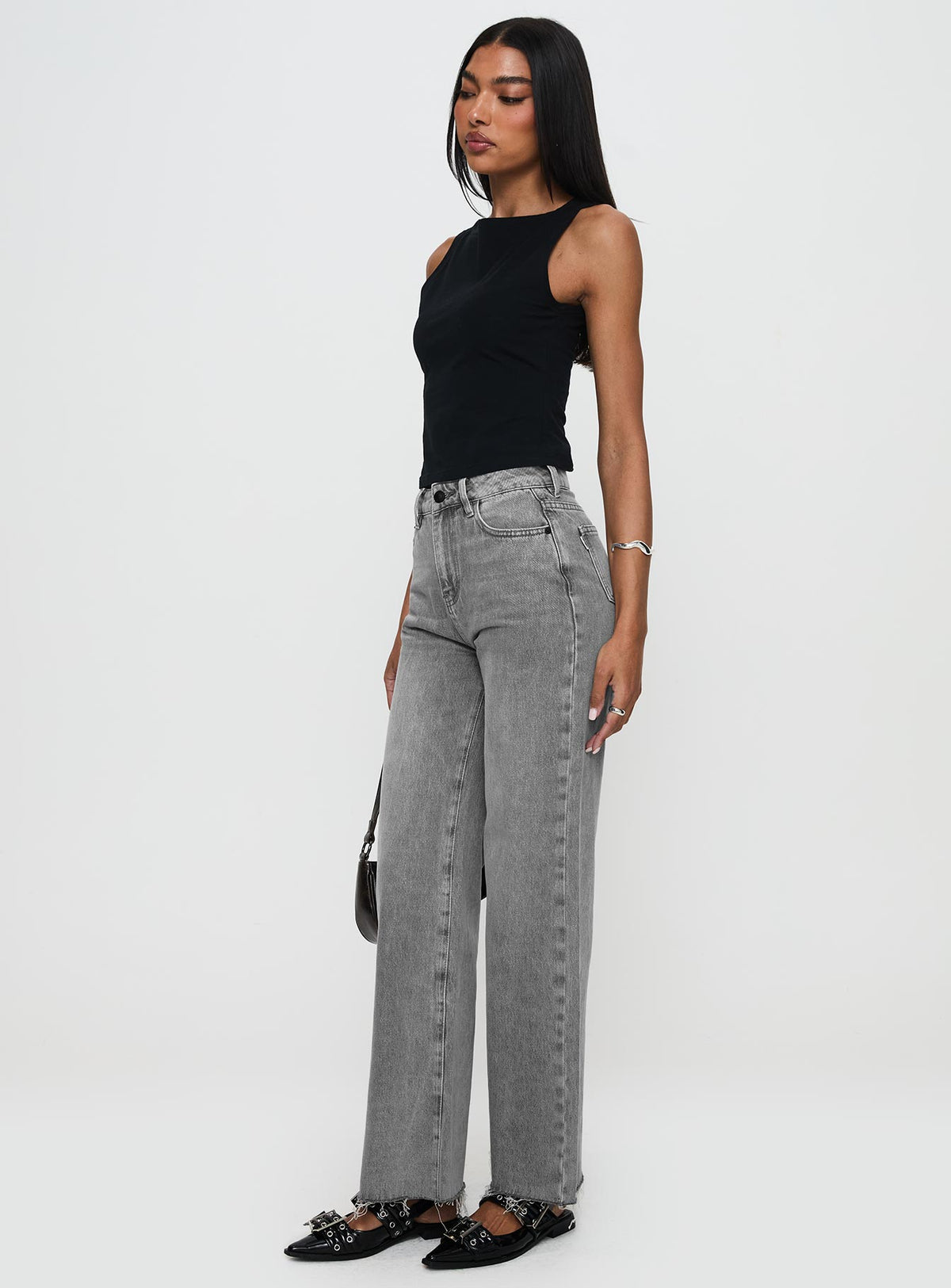 side view of model wearing Princess Polly Henesey Raw Hem Jeans Washed Grey High Waisted 