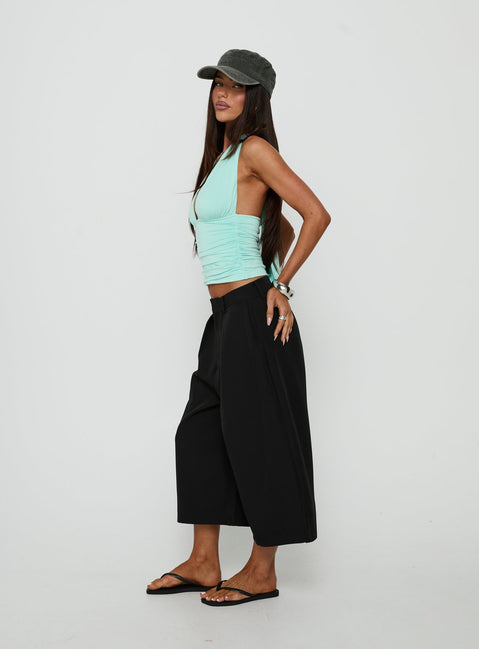 Crafted with the Busy Busy Low Baggy Capri Pant Black in womens-regular-pants with low-rise side view of model wearing Princess Polly