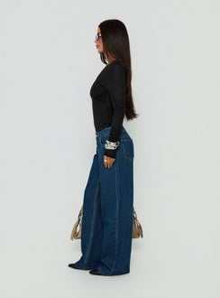 Showcasing Tidal Wave Low Rise Straight Leg Jeans Dark Blue Wash in womens-jeans side view of model wearing Princess Polly
