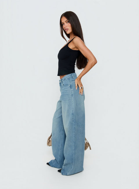 Featuring Naylor Mid Rise Wide Leg Jeans Light Wash Denim Light Blue Wash Petite in womens-jeans with mid-rise side view of model wearing