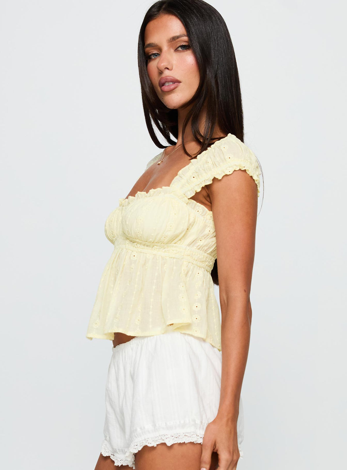 side view of model wearing Princess Polly Summerfield Top Lemon Short Sleeves Square Neck 