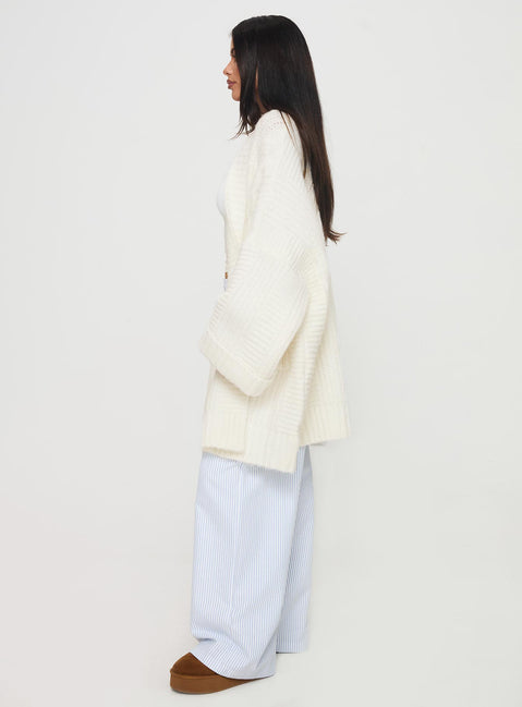 side view of model wearing Princess Polly Paisleigh Cable Knit Cardigan Cream Longline Jumpers Jumpers 