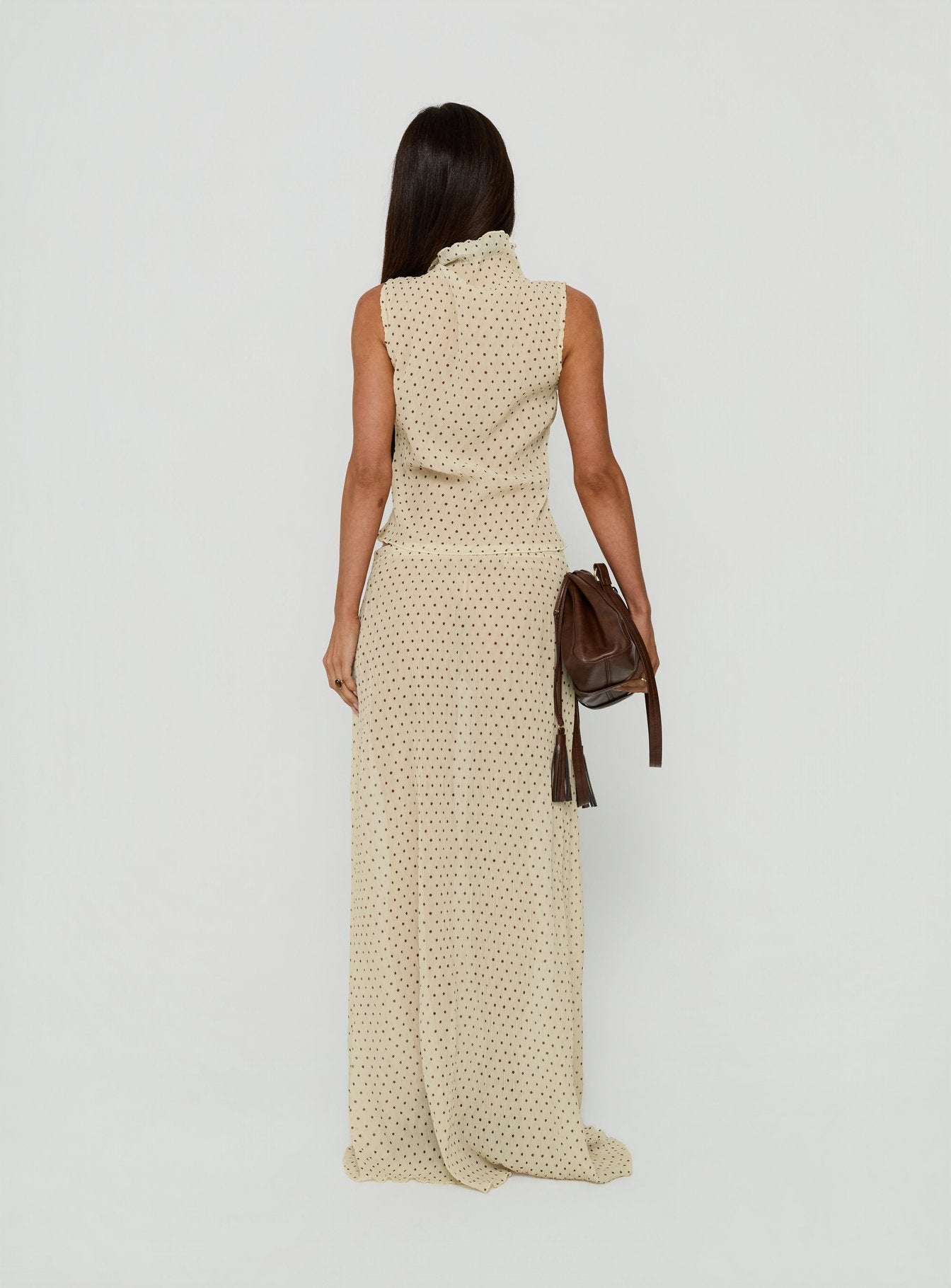 Showcasing the Ford Maxi Skirt Butter Chocolate Polka Dot in womens-skirts with a maxi length silhouette back view of model wearing Princess Polly