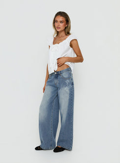 Johnni Floral Printed Low Rise Jeans Mid Wash womens-jeans side view of model wearing Princess Polly