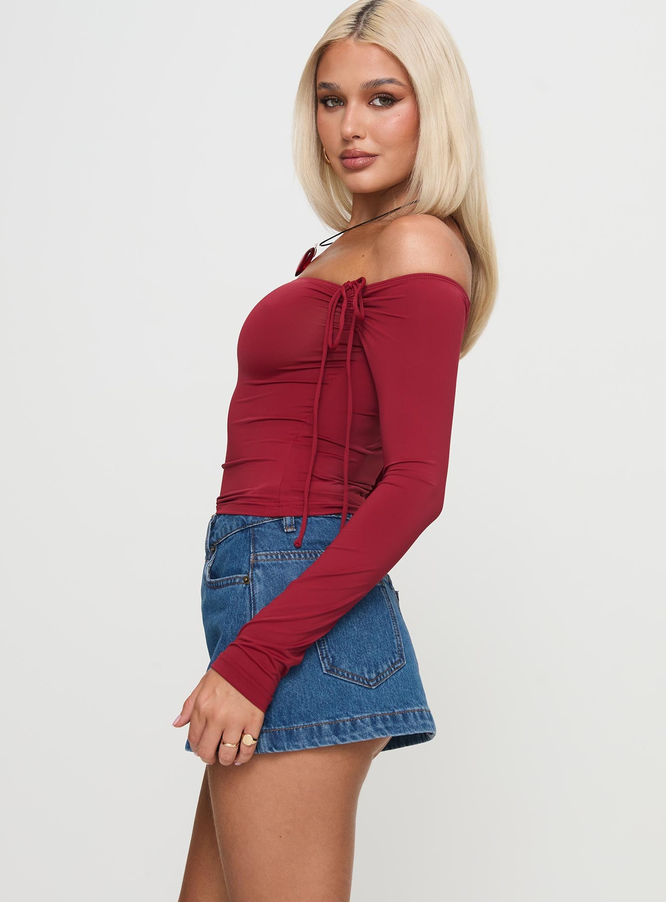  side view of model wearing Princess Polly Nicolina Low Rise Denim Mini Skirt Light Wash Tall Mini Skirts 