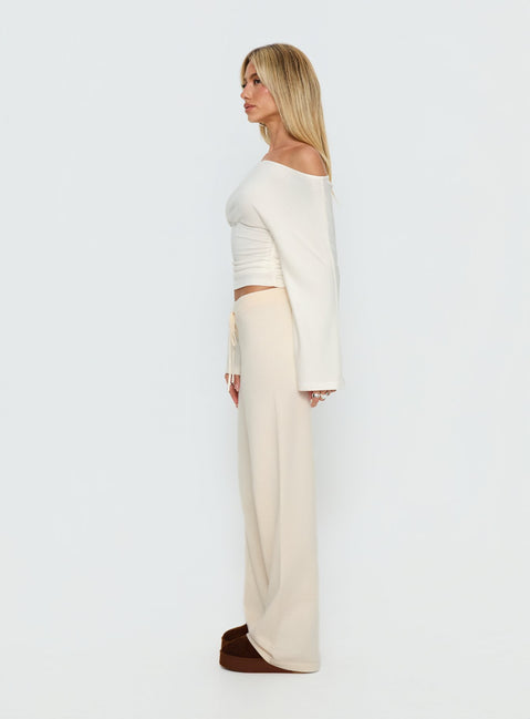 side view of model wearing Princess Polly Felisha Low Waist Knit Pants White Mid Rise Pants 