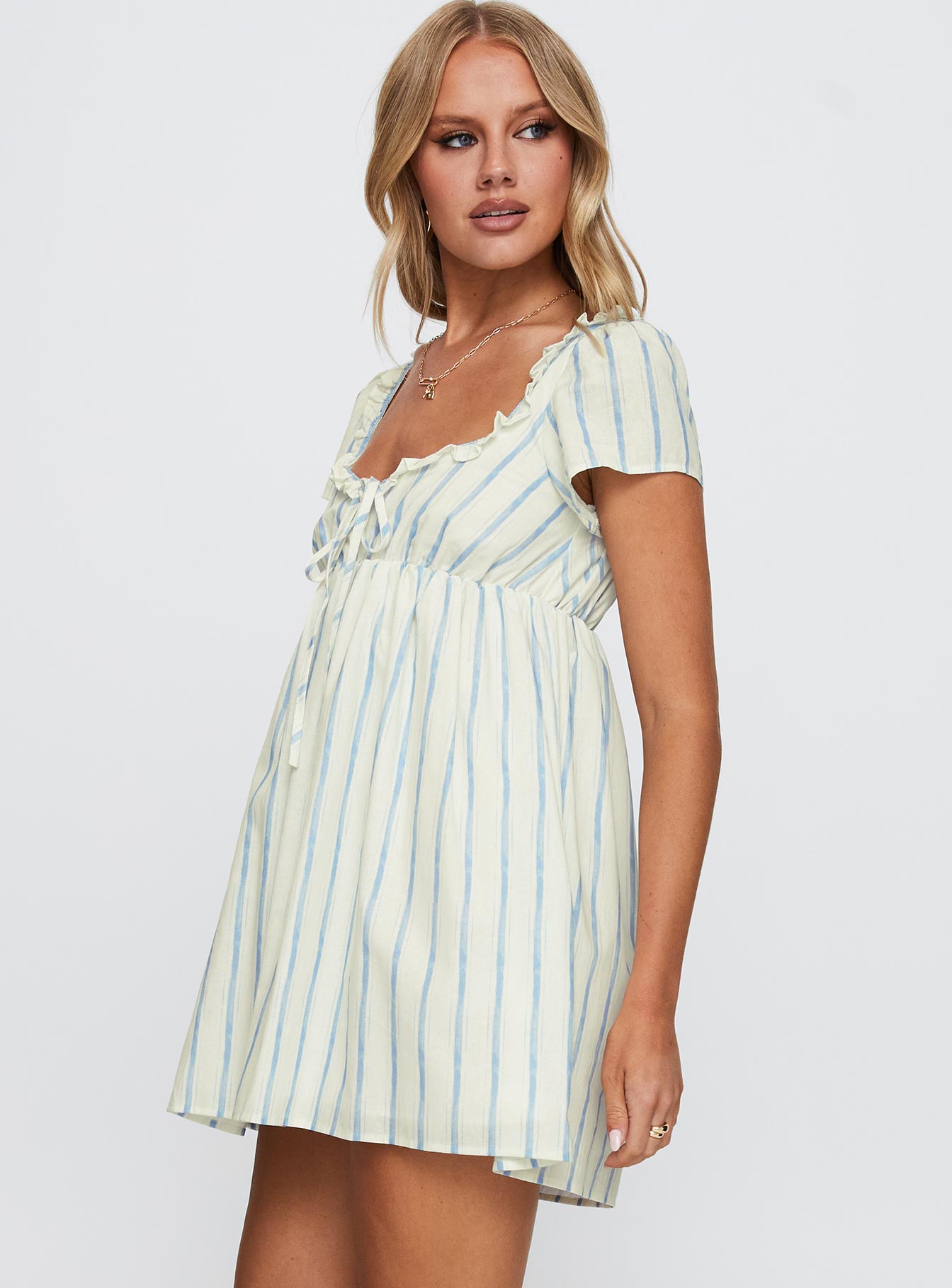 side view of model wearing Princess Polly Monsterrat Mini Dress Blue Stripe Sweetheart Neckline 