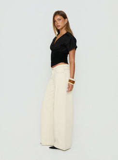 Designed with the Ramos Low Rise Wide Leg Jeans Cream in womens jeans featuring low-rise waist side view of model wearing Princess Polly