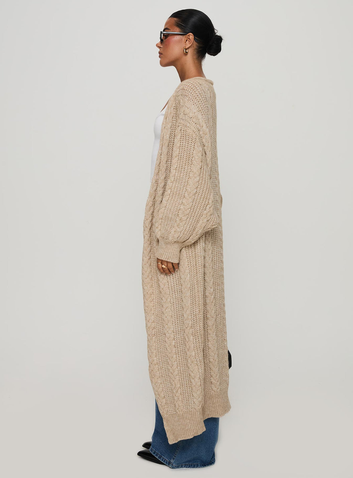 side view of model wearing Princess Polly Orkid Cable Knit Cardigan Beige Long 