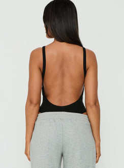 Featuring the Nerinah Ribbed Bodysuit Black womens-bodysuit in sleeveless back view of model wearing