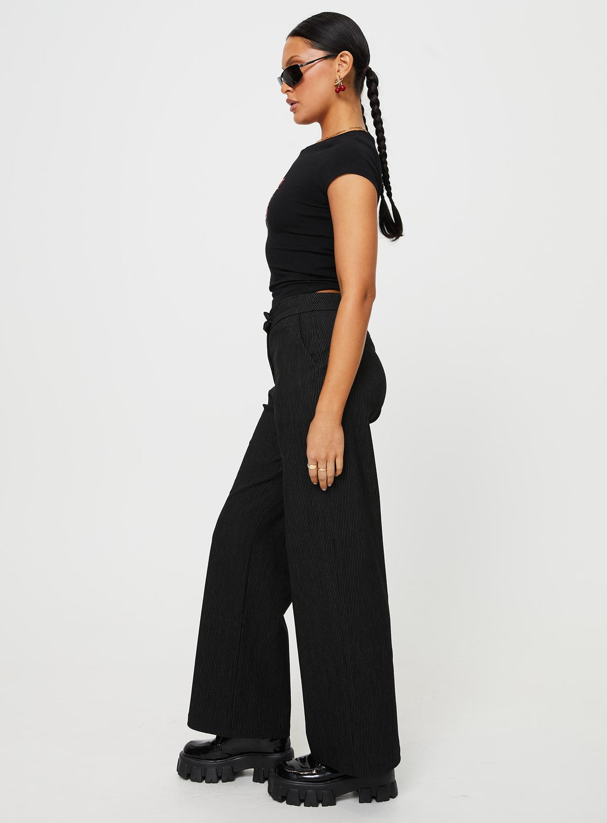 side view of model wearing Princess Polly Jeller Pinstripe Pants Black Petite High Waisted Pants 