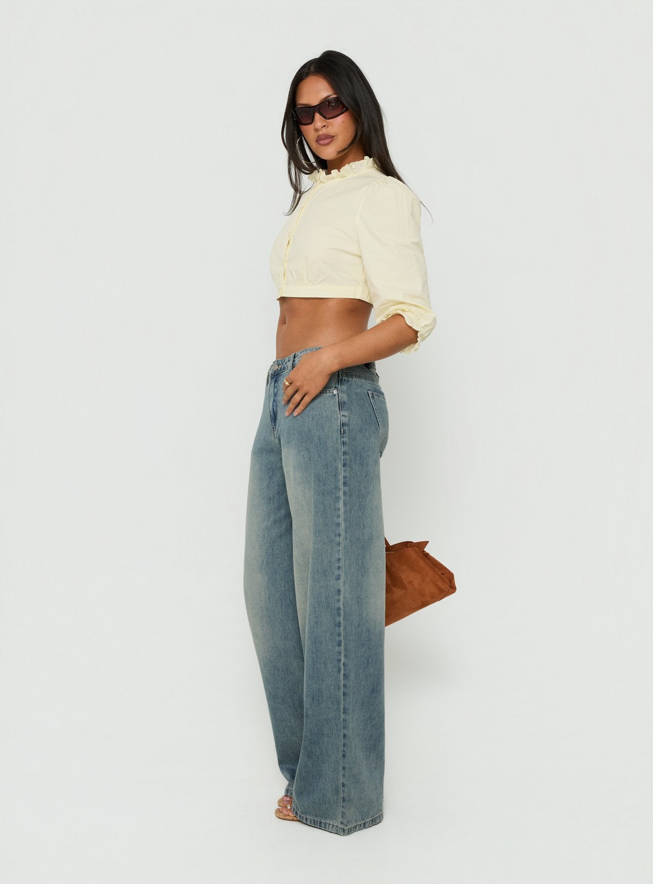 Crafted from Karlos Low Rise Cinched Baggy Jeans Vintage Mid Blue Wash womens-jeans featuring low-rise side view of model wearing Princess Polly