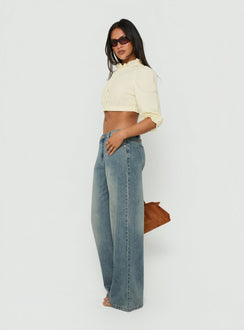 Crafted from Karlos Low Rise Cinched Baggy Jeans Vintage Mid Blue Wash womens-jeans featuring low-rise side view of model wearing Princess Polly