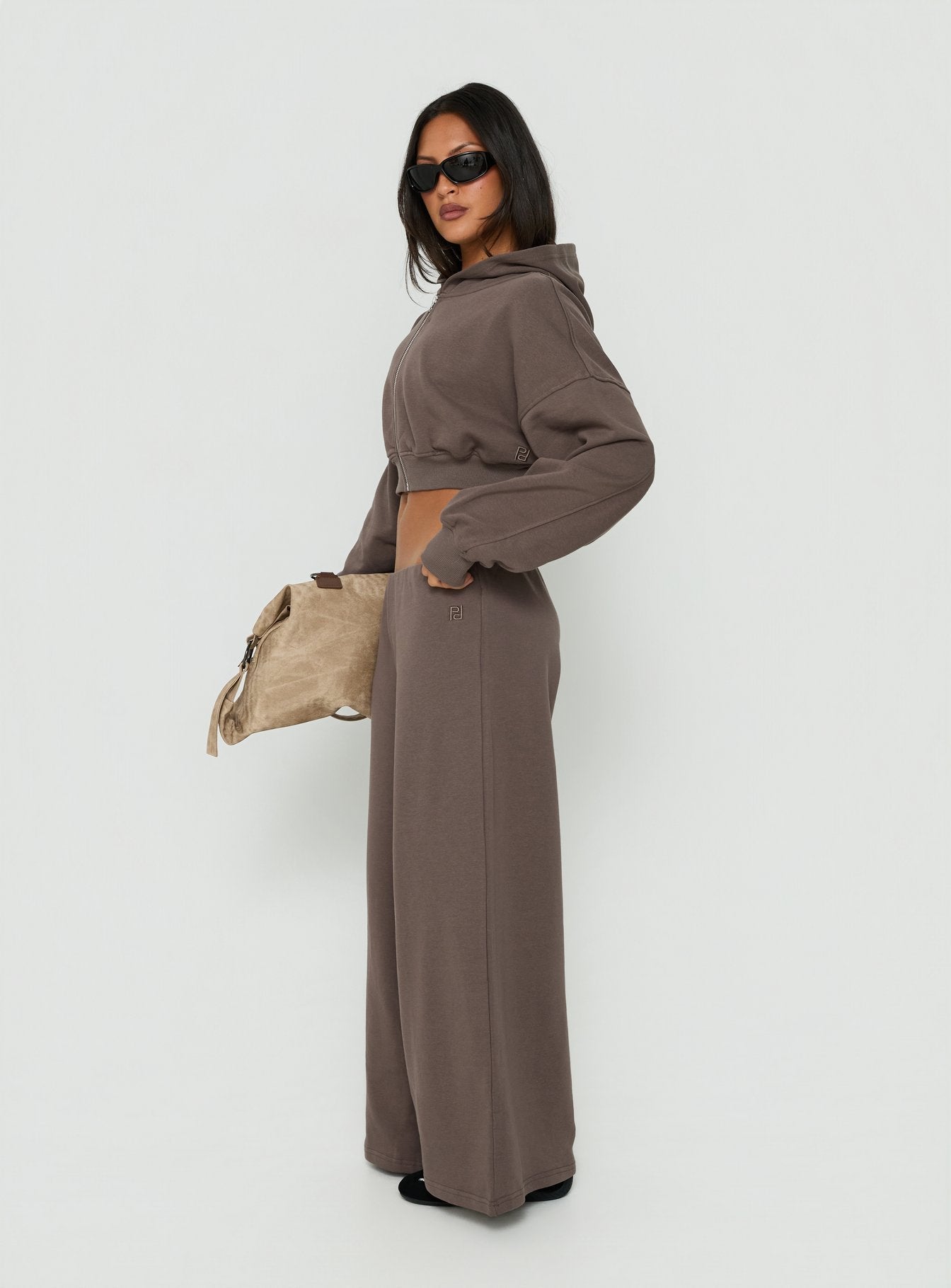 Presenting Kaeya Fleece Wide Leg Low Rise Pants Grey in womens-regular-pants with low-rise waist on-body view of model wearing Princess Polly
